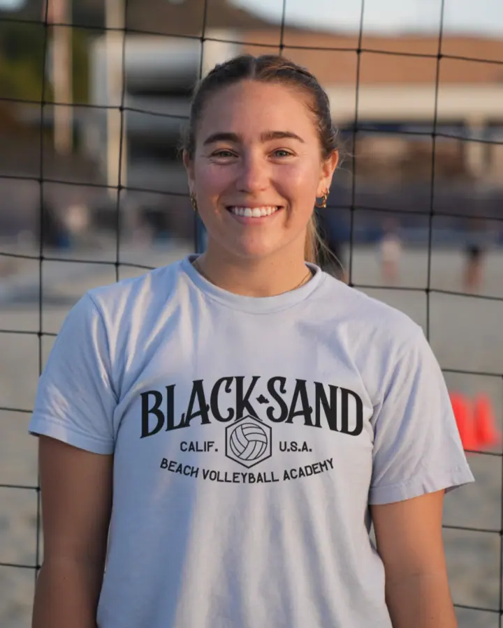 Coach Brooke Bunker on the sand court in a Black Sand shirt